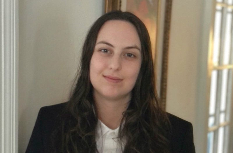 Young woman smiling wearing business attire